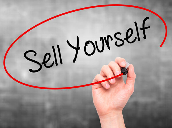 Man Hand writing Sell Yourself with black marker on visual scree