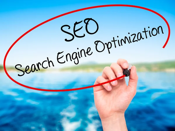 stock image Man Hand writing SEO Search Engine Optimization with black marke