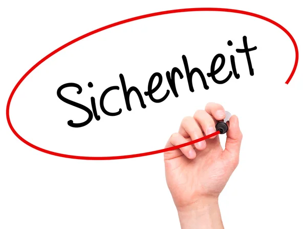 男人手用黑色记号笔写 Sicherheit （德国的安全） — 图库照片