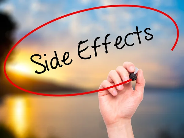 Man Hand writing Side Effects with black marker on visual screen — Stock Photo, Image