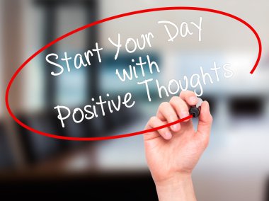 Man Hand writing Start your Dat with Positive Thoughts with blac
