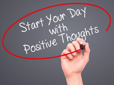 Man Hand writing Start your Dat with Positive Thoughts with blac
