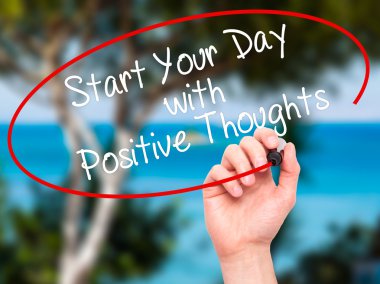 Man Hand writing Start your Dat with Positive Thoughts with blac