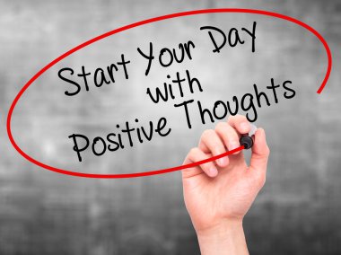 Man Hand writing Start your Dat with Positive Thoughts with blac