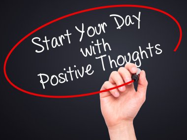 Man Hand writing Start your Dat with Positive Thoughts with blac