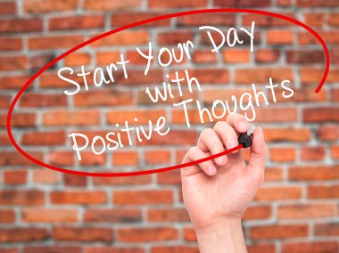 Man Hand writing Start your Dat with Positive Thoughts with blac