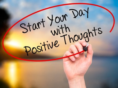 Man Hand writing Start your Dat with Positive Thoughts with blac