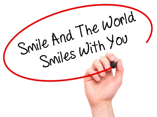 Man Hand writing Smile And The World Smiles To You with black ma — Stock Photo, Image