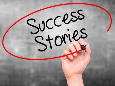 Man Hand writing Success Stories with black marker on visual scr