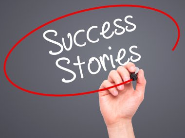Man Hand writing Success Stories with black marker on visual scr