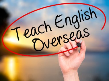 Man Hand writing Teach English Overseas with black marker on vis clipart