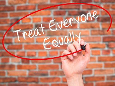 Man Hand writing Treat Everyone Equally with black marker on vis