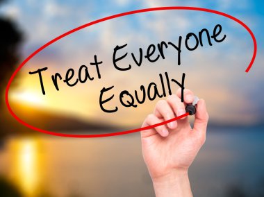 Man Hand writing Treat Everyone Equally with black marker on vis