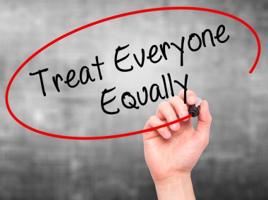 Man Hand writing Treat Everyone Equally with black marker on vis