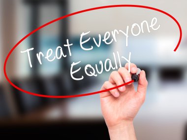 Man Hand writing Treat Everyone Equally with black marker on vis