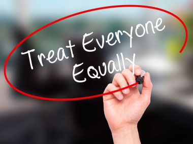 Man Hand writing Treat Everyone Equally with black marker on vis