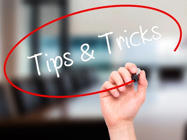 Man Hand writing Tips &amp; Tricks with black marker on visual s — Stock Photo, Image