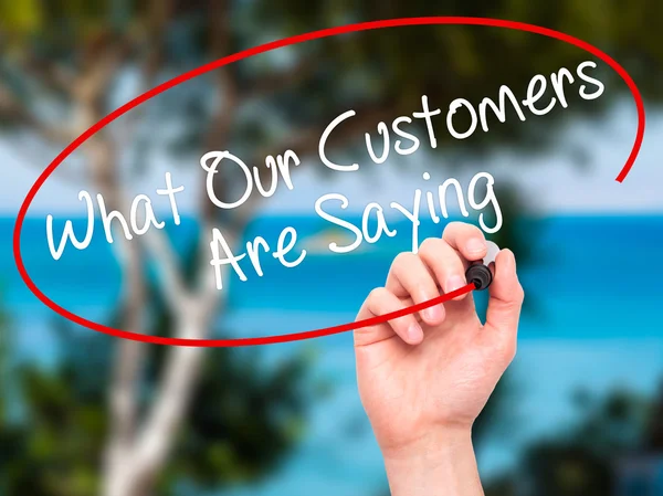 Man Hand writing What Our Customers Are Saying with black marker — Stock Photo, Image