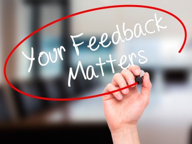 Man Hand writing Your Feedback Matters with black marker on visu