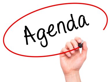 Man Hand writing Agenda with marker on transparent wipe board