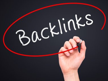 Man Hand writing Backlinks with marker on transparent wipe board