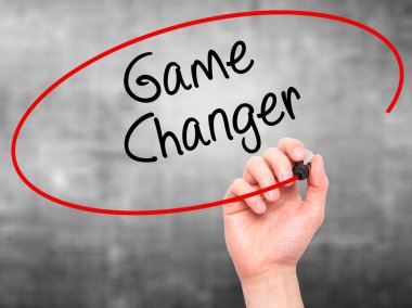 Man Hand writing Game Changer with marker on transparent wipe bo