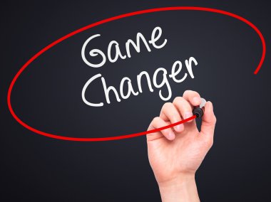 Man Hand writing Game Changer with marker on transparent wipe bo