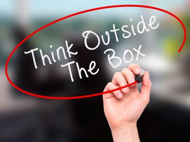 Man Hand writing Think Outside The Box with marker on transparen