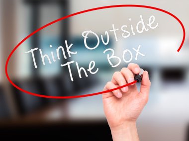 Man Hand writing Think Outside The Box with marker on transparen