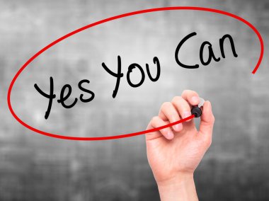Man Hand writing Yes You Can with marker on transparent wipe boa