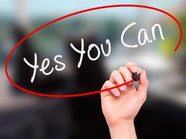 Man Hand writing Yes You Can with marker on transparent wipe boa