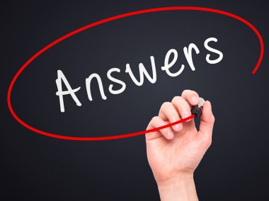 Man Hand writing Answers with marker on transparent wipe board