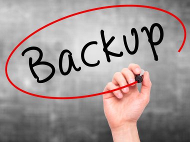 Man Hand writing Backup with marker on transparent wipe board