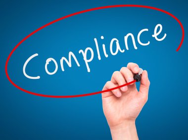 Man Hand writing Compliance with marker on transparent wipe boar