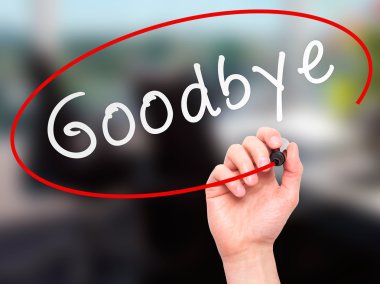 Man Hand writing Goodbye with marker on transparent wipe board
