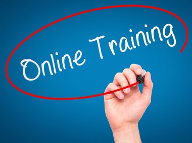 Man Hand writing Online Training with marker on transparent wipe