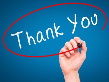 Man Hand writing Thank You with marker on transparent wipe board