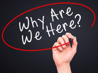 Man Hand writing Why Are We Here black marker on visual screen