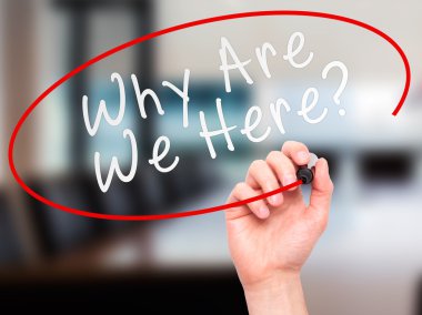 Man Hand writing Why Are We Here black marker on visual screen