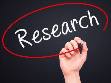 Man Hand writing Research with marker on transparent wipe board