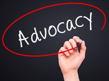 Man Hand writing Advocacy with marker on transparent wipe board