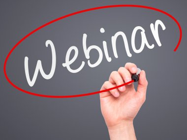 Man Hand writing Webinar black marker on visual screen