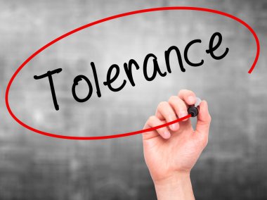 Man Hand writing Tolerance with marker on transparent wipe board