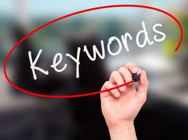 Man hand writing Keywords on visual screen