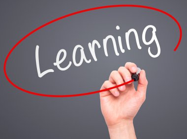 Man Hand writing Learning with marker on transparent wipe board