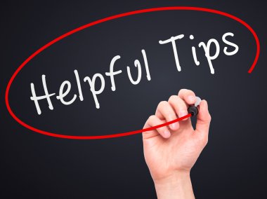Man hand writing Helpful Tips on visual screen