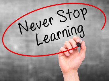 Man hand writing Never Stop Learning on visual screen