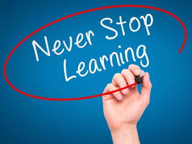 Man hand writing Never Stop Learning on visual screen