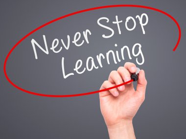 Man hand writing Never Stop Learning on visual screen