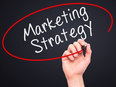 Man Hand writing Marketing Strategy with marker on transparent w